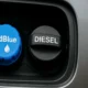 Close-up of a blue AdBlue cap beside a black diesel cap on a silver van – header for AdBlue removal Stoke on Trent