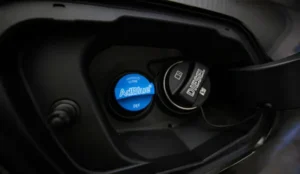 Close-up of a car's AdBlue and diesel filler caps inside the fuel door