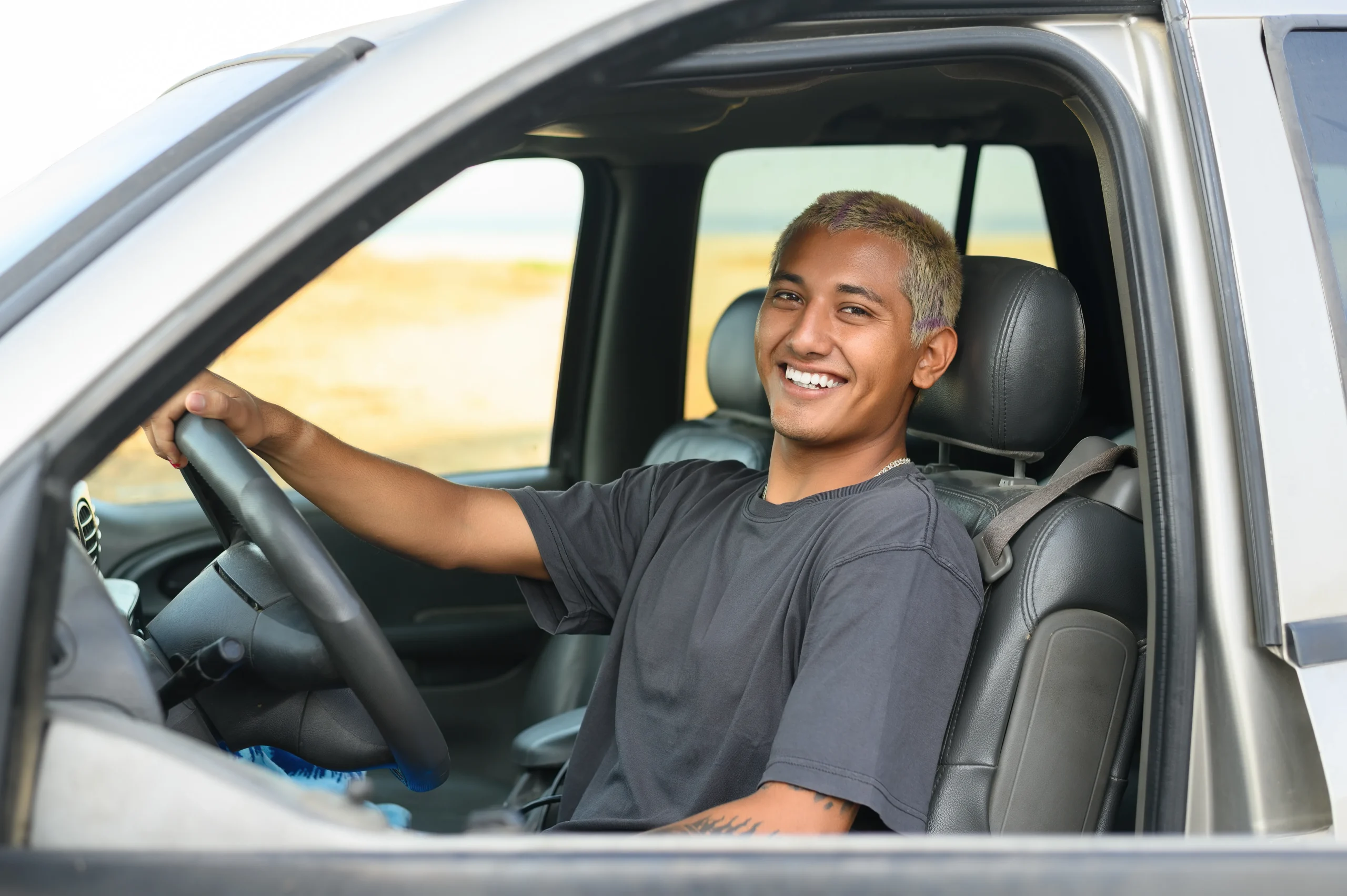 Smiling van driver sitting confidently behind the wheel