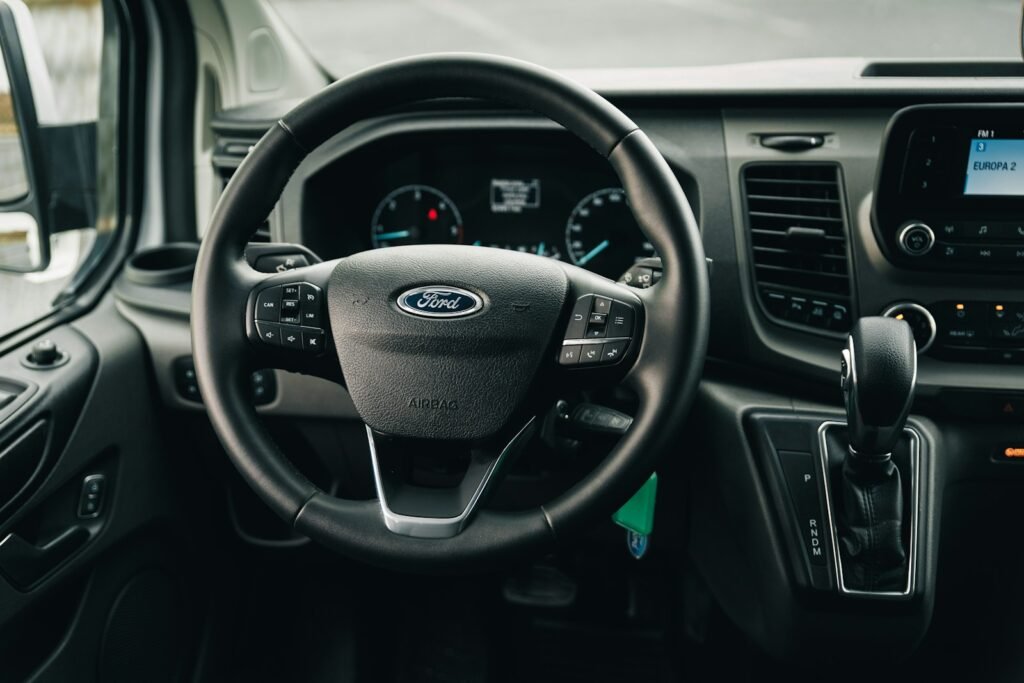 the interior of a car with a steering wheel and dashboard - ford transit