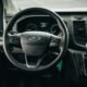 the interior of a car with a steering wheel and dashboard - ford transit