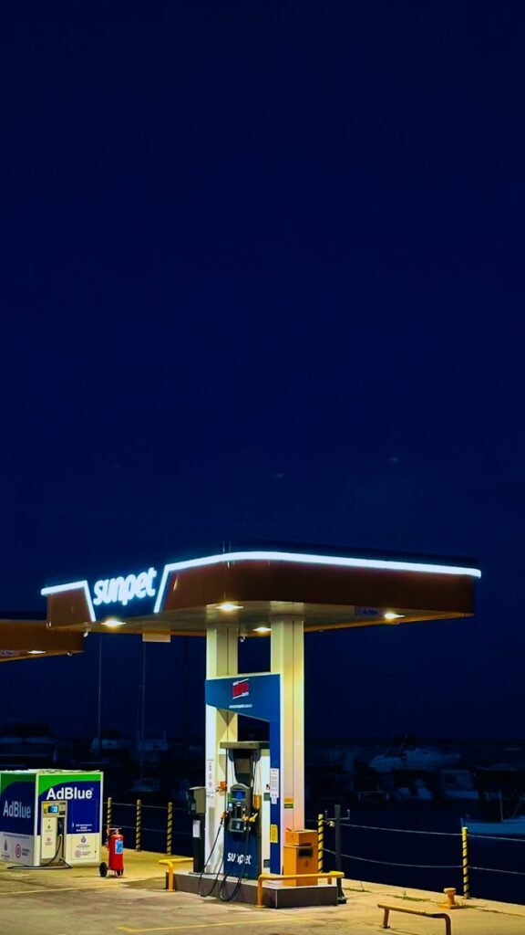 Gas station illuminated at night under a dark sky