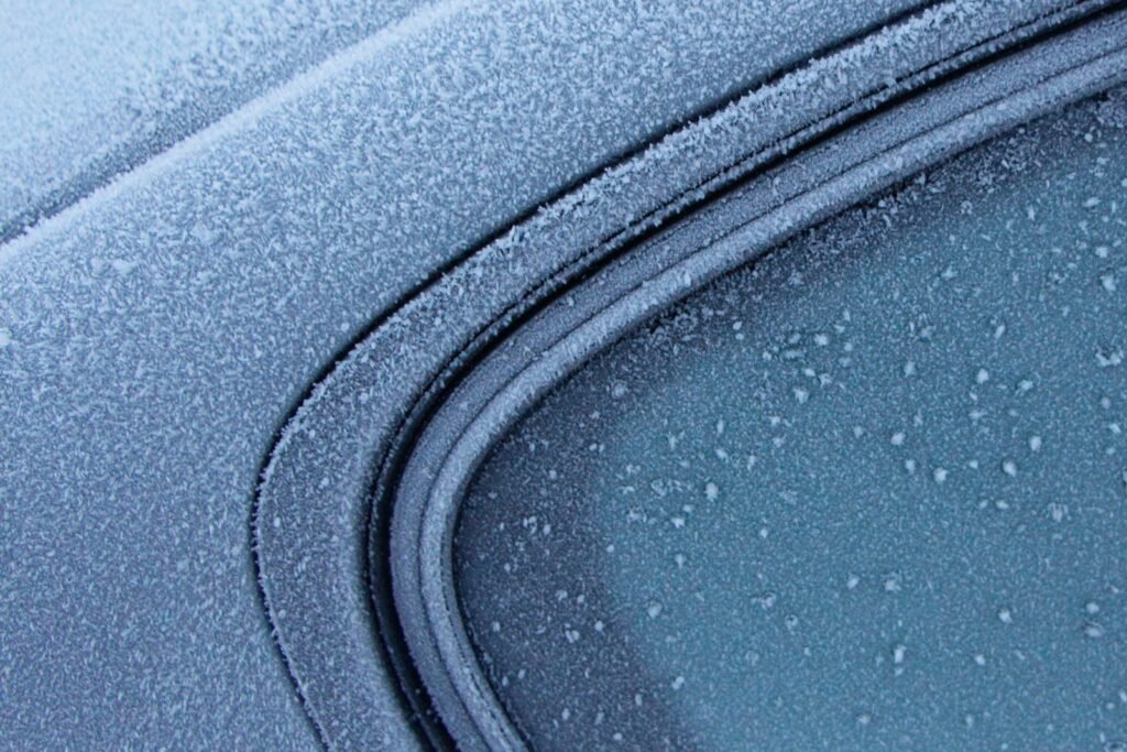 a close up of a car's windshield with drops of water on it