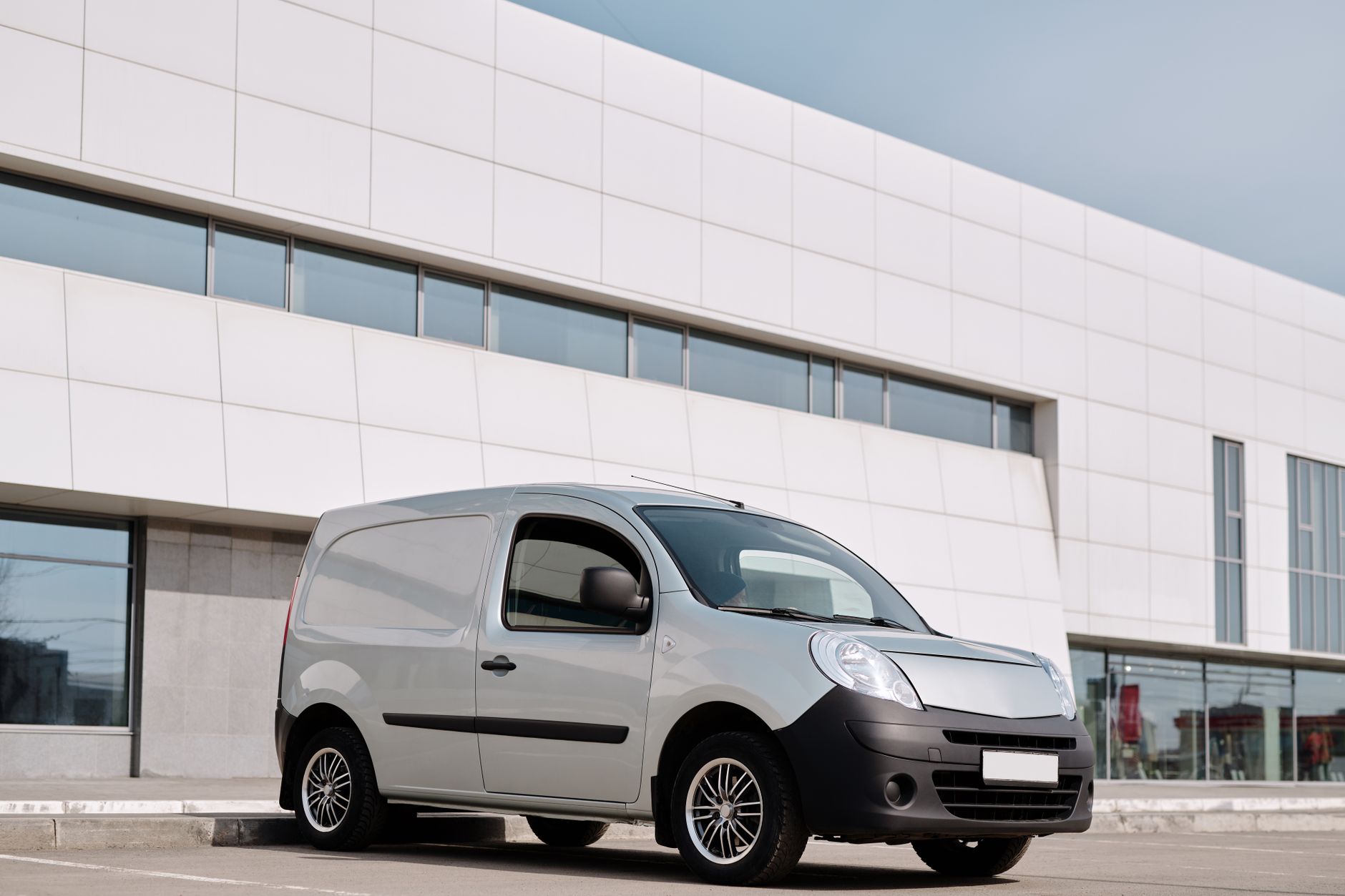 AdBlue fleet management - an unbranded white panel van parked outside a commercial building