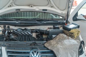 AdBlue delete insurance — diesel engine bay being inspected with a diagnostic scan tool