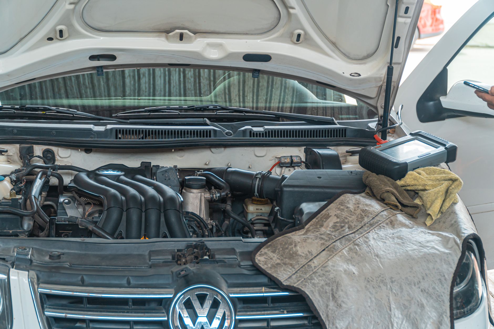 AdBlue delete insurance — diesel engine bay being inspected with a diagnostic scan tool
