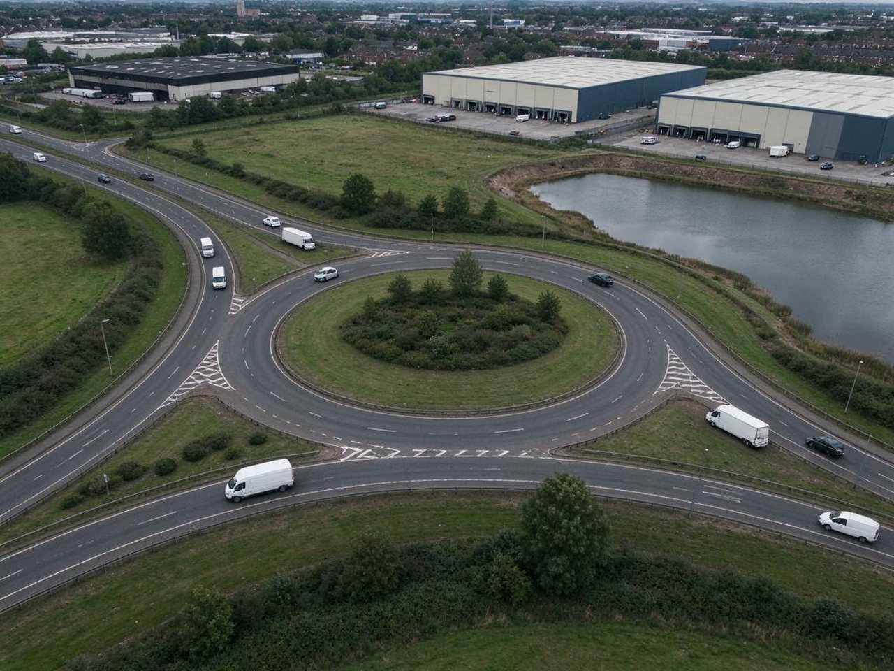 Vans and lorries on a roundabout by distribution warehouses on the edge of Cannock